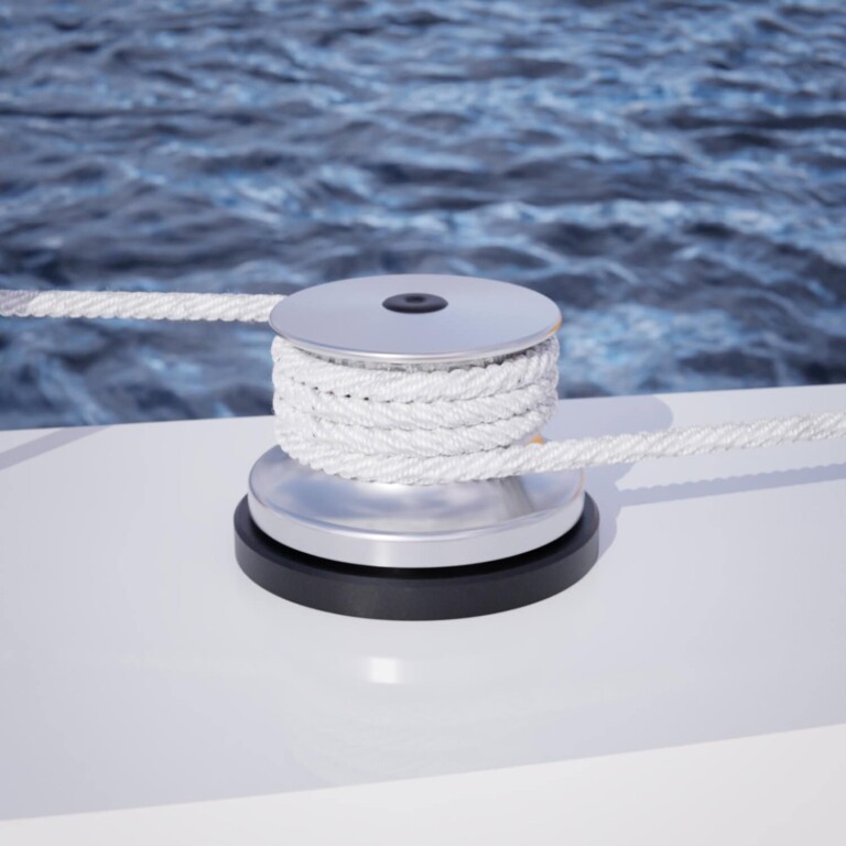 Stainless steel boat winch with white rope on a yacht deck.