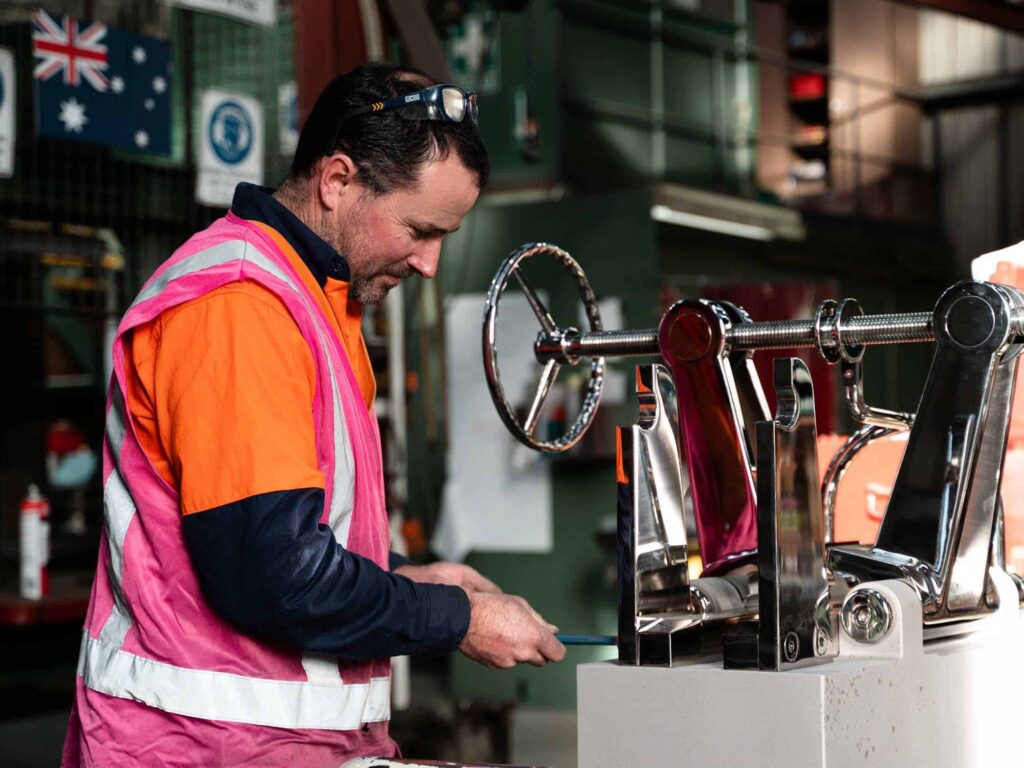 High-quality industrial engineering machinery being inspected by a technician at Muir Engineering.