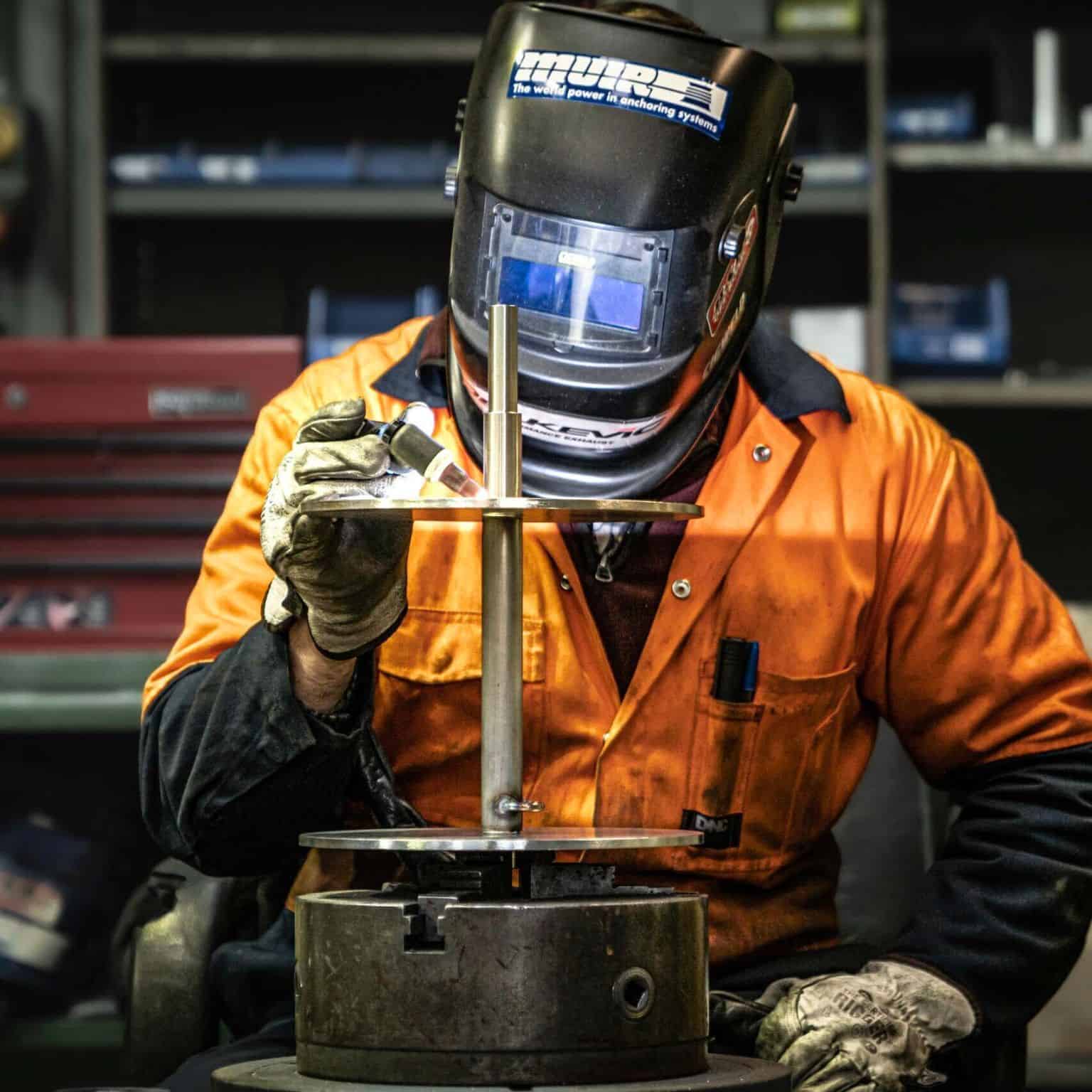 Muir technician welding stainless steel drum winch in Australian manufacturing workshop
